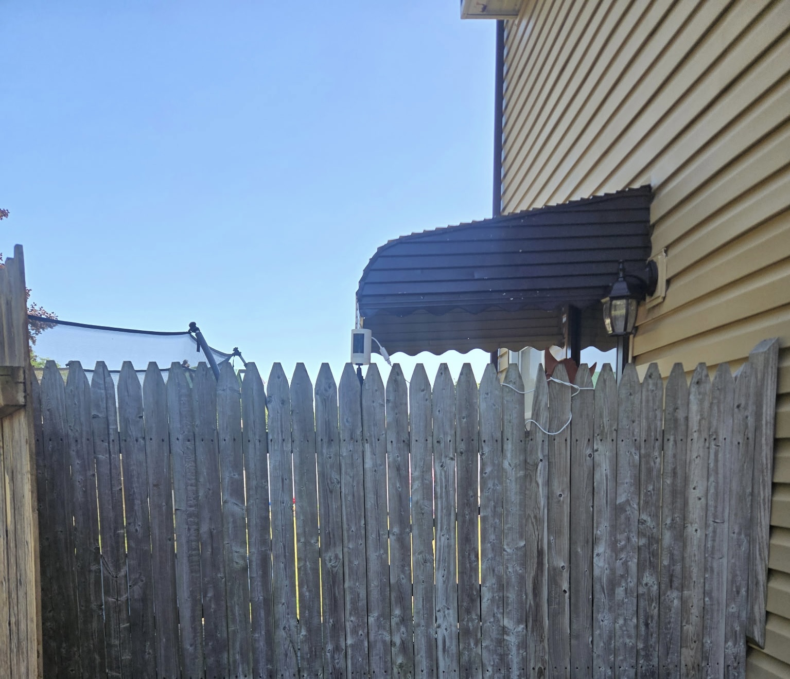 Wooden fence before pressure washing with buildup and stains