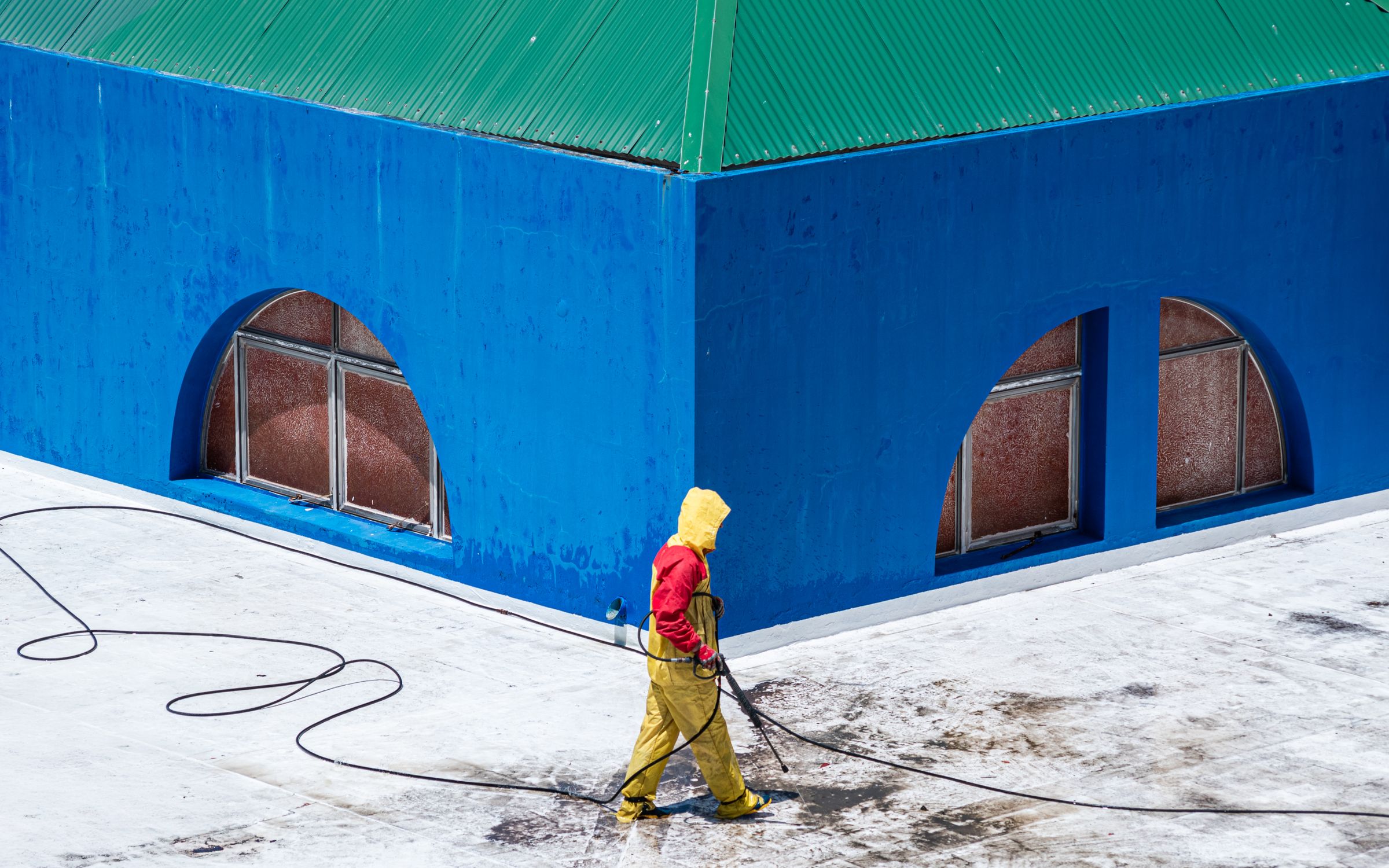 Worker power washing an exterior surface